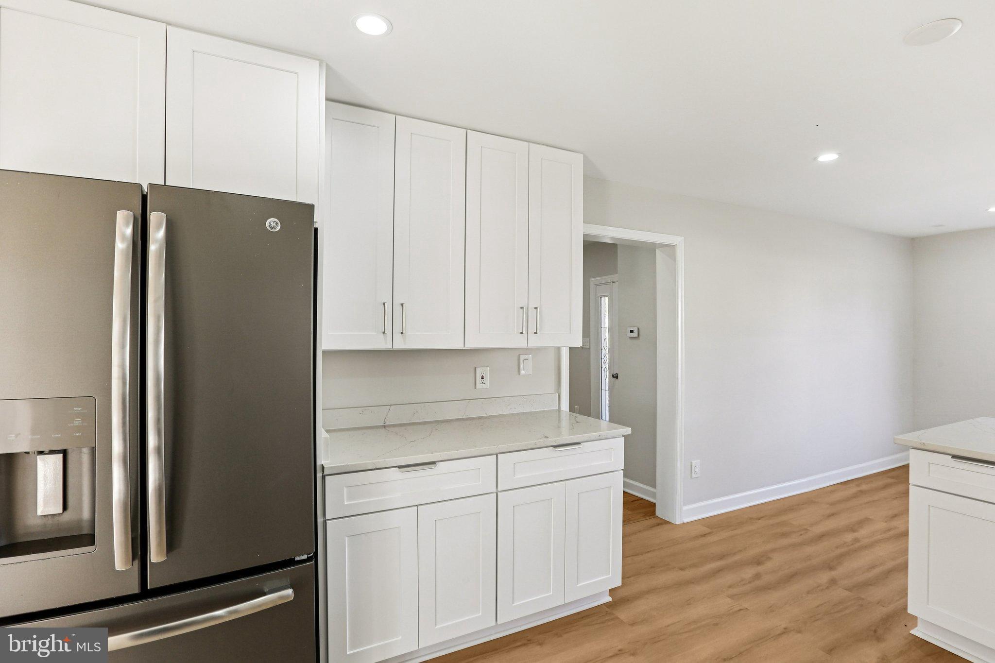10571 Scaggsville Road Laurel, MD 20723 - Photo 17 of 60 a kitchen with a refrigerator and a sink