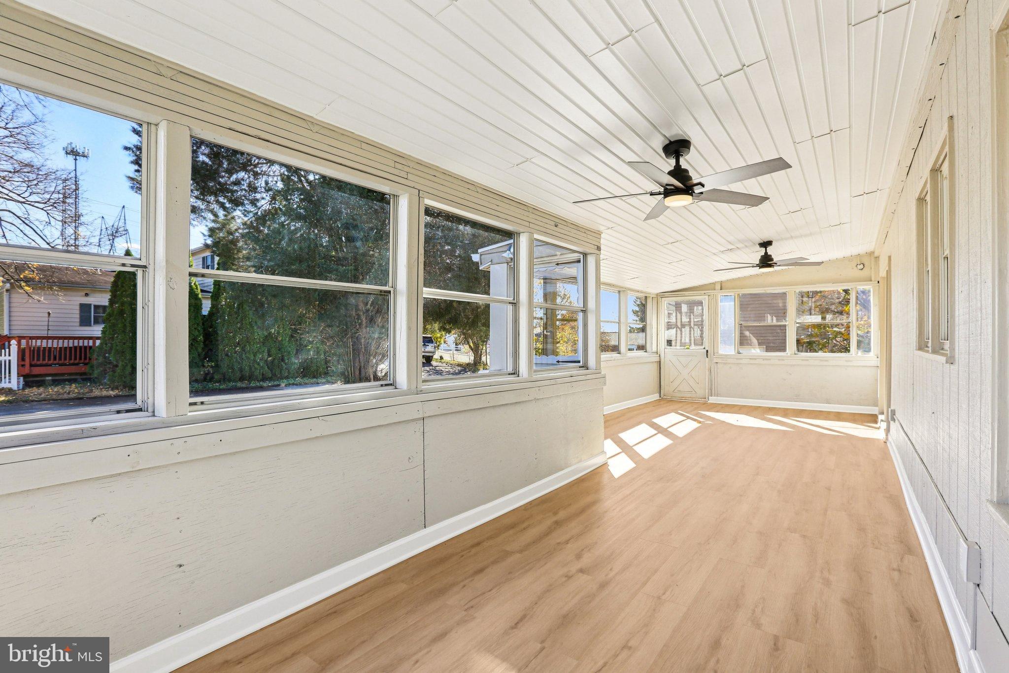 10571 Scaggsville Road Laurel, MD 20723 - Photo 21 of 60 wooden floor in an empty room with a window