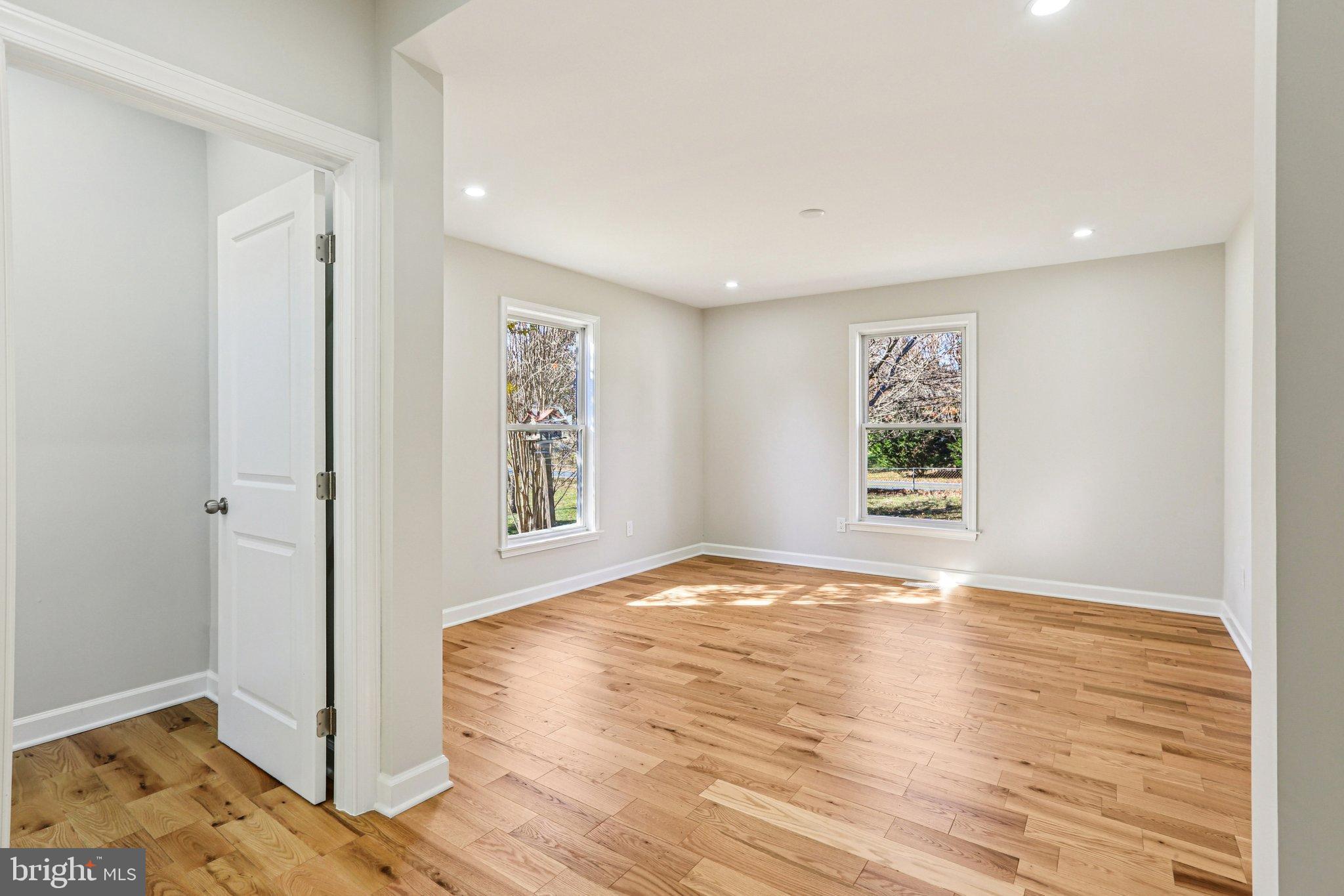 10571 Scaggsville Road Laurel, MD 20723 - Photo 22 of 60 a view of an empty room with wooden floor and a window