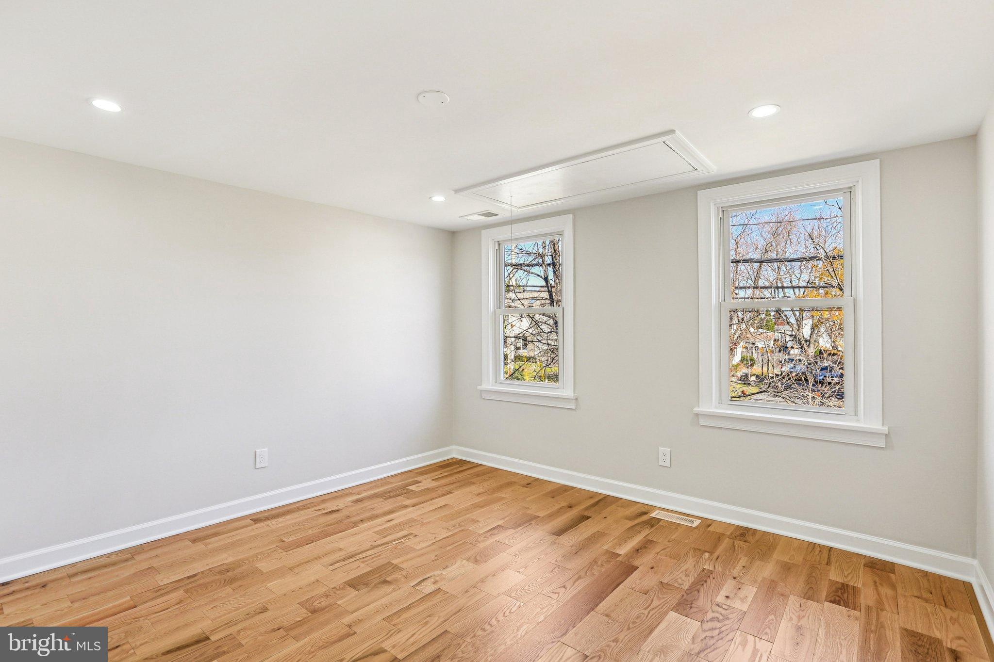10571 Scaggsville Road Laurel, MD 20723 - Photo 25 of 60 a view of an empty room with wooden floor and a window