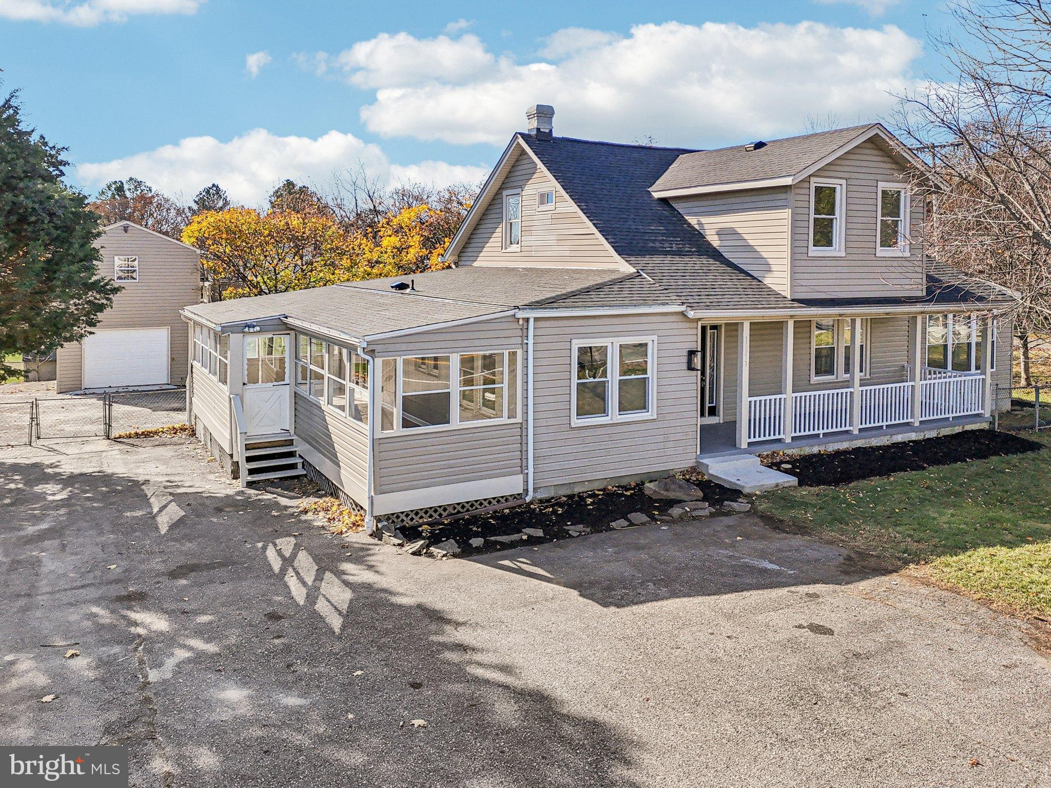 10571 Scaggsville Road Laurel, MD 20723 - Photo 3 of 60 a front view of a house with a garden