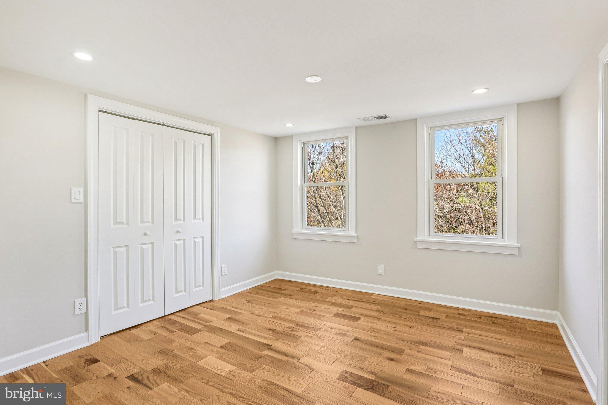 10571 Scaggsville Road Laurel, MD 20723 - Photo 31 of 60 a view of an empty room with wooden floor and a window