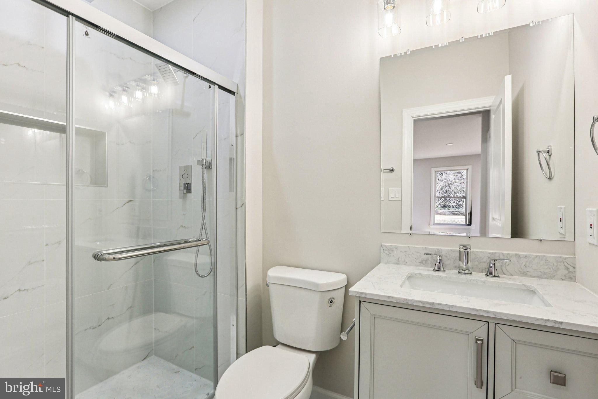 10571 Scaggsville Road Laurel, MD 20723 - Photo 32 of 60 a bathroom with a granite countertop sink toilet and shower