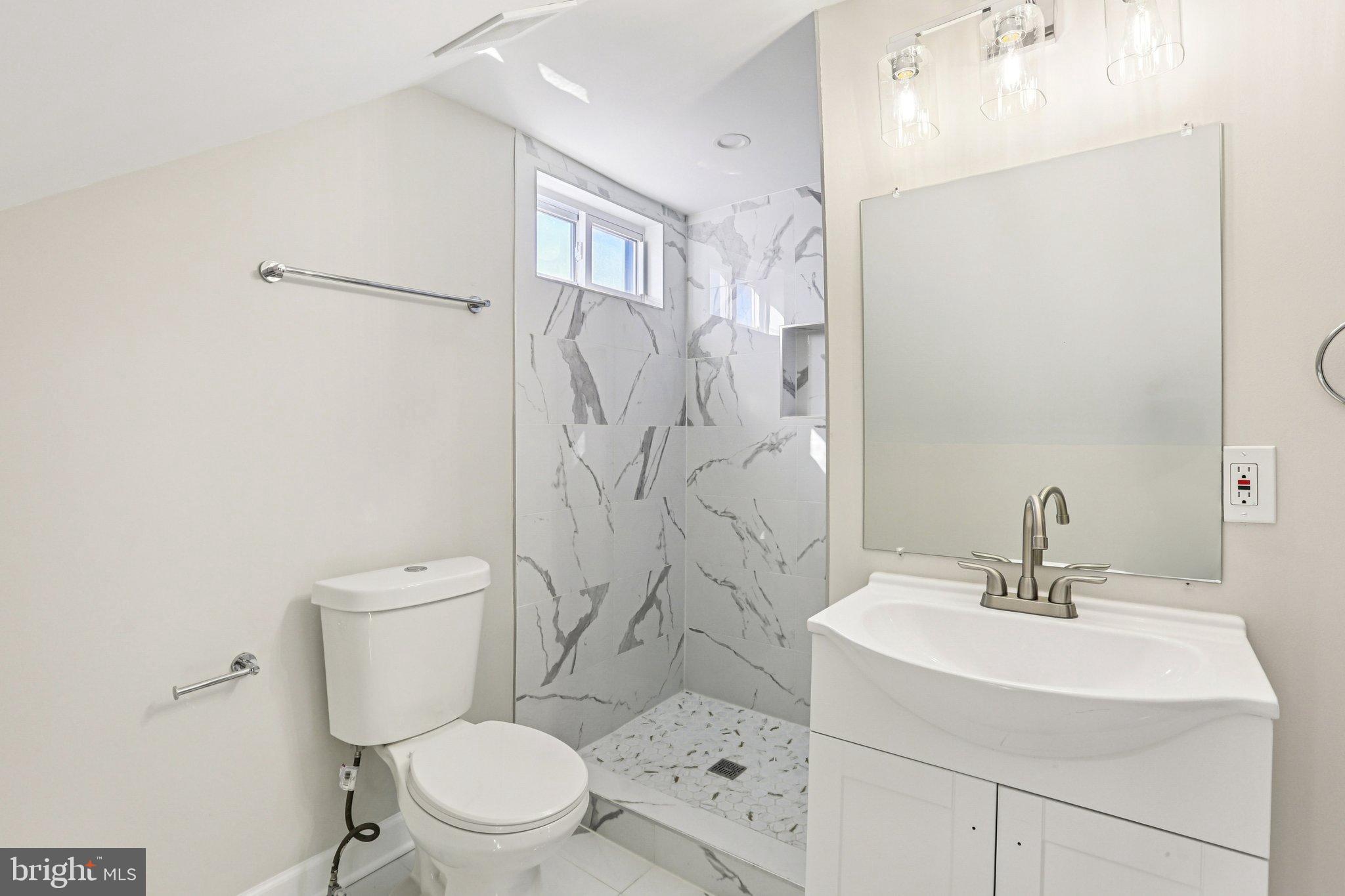 10571 Scaggsville Road Laurel, MD 20723 - Photo 34 of 60 a bathroom with a sink toilet and shower