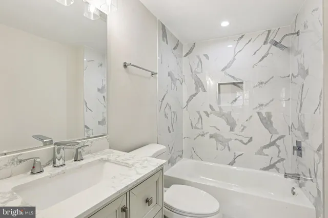 a white house that has a tree in front of it