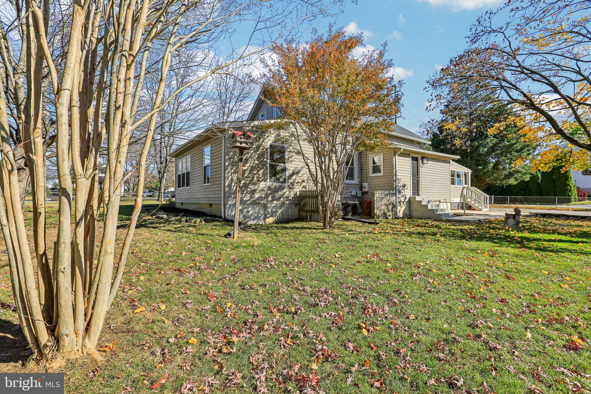 10571 Scaggsville Road Laurel, MD 20723 - Photo 40 of 60 a white house that has a tree in front of it