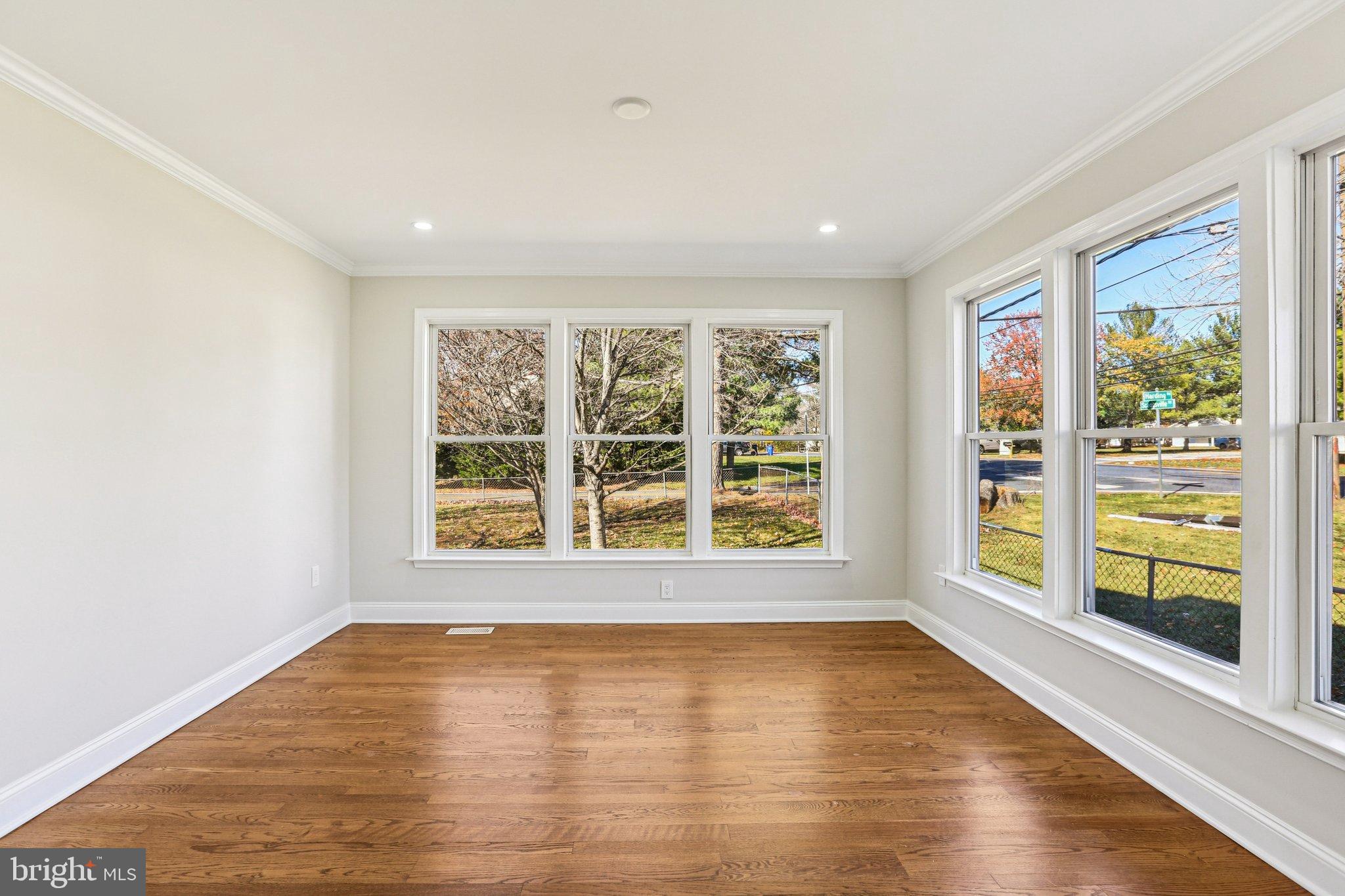 10571 Scaggsville Road Laurel, MD 20723 - Photo 10 of 60 a view of an empty room with a window and wooden floor