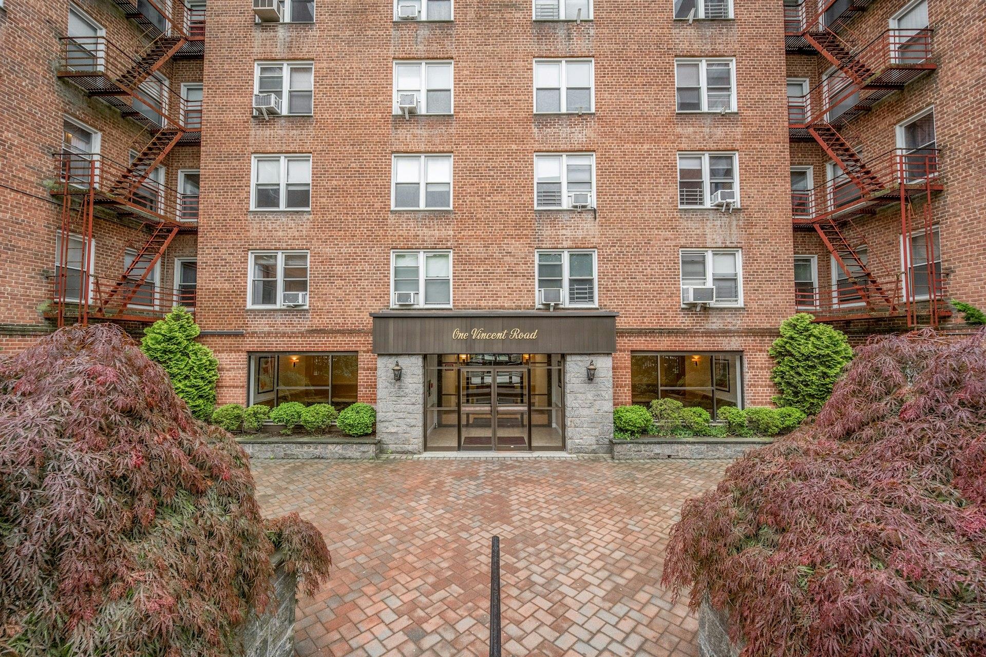 a front view of a building with garden