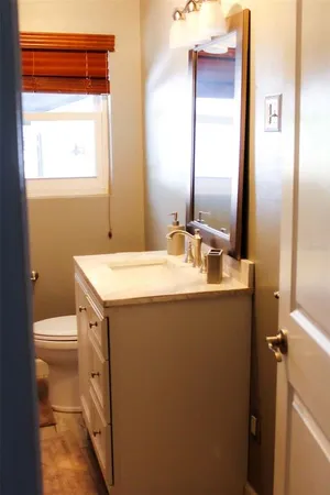 a bathroom with a sink toilet and mirror
