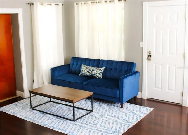 a living room with furniture and a window