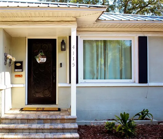 a front view of a house with a potted plant