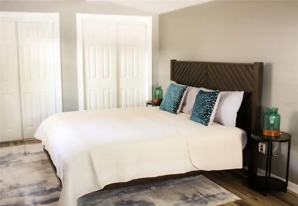 a bed sitting in a bedroom next to a window
