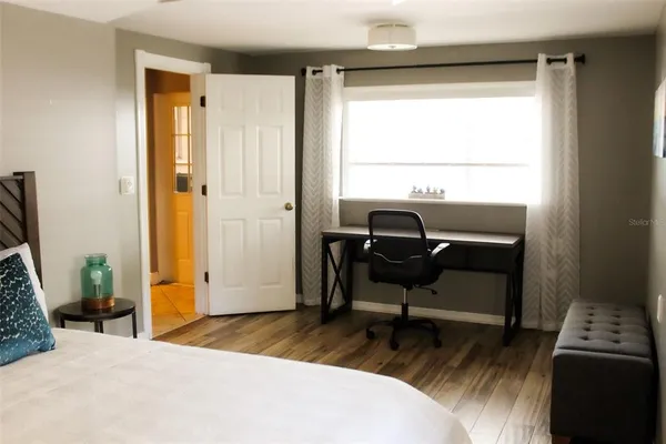 a bedroom with a bed and a window