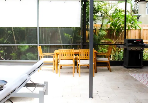 a living room with furniture and a floor to ceiling window