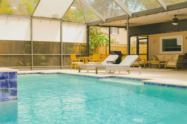 a view of a backyard with swimming pool