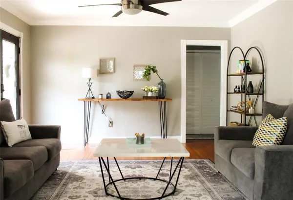 a living room with furniture and wooden floor