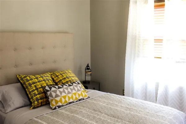 a bedroom with a bed and a window