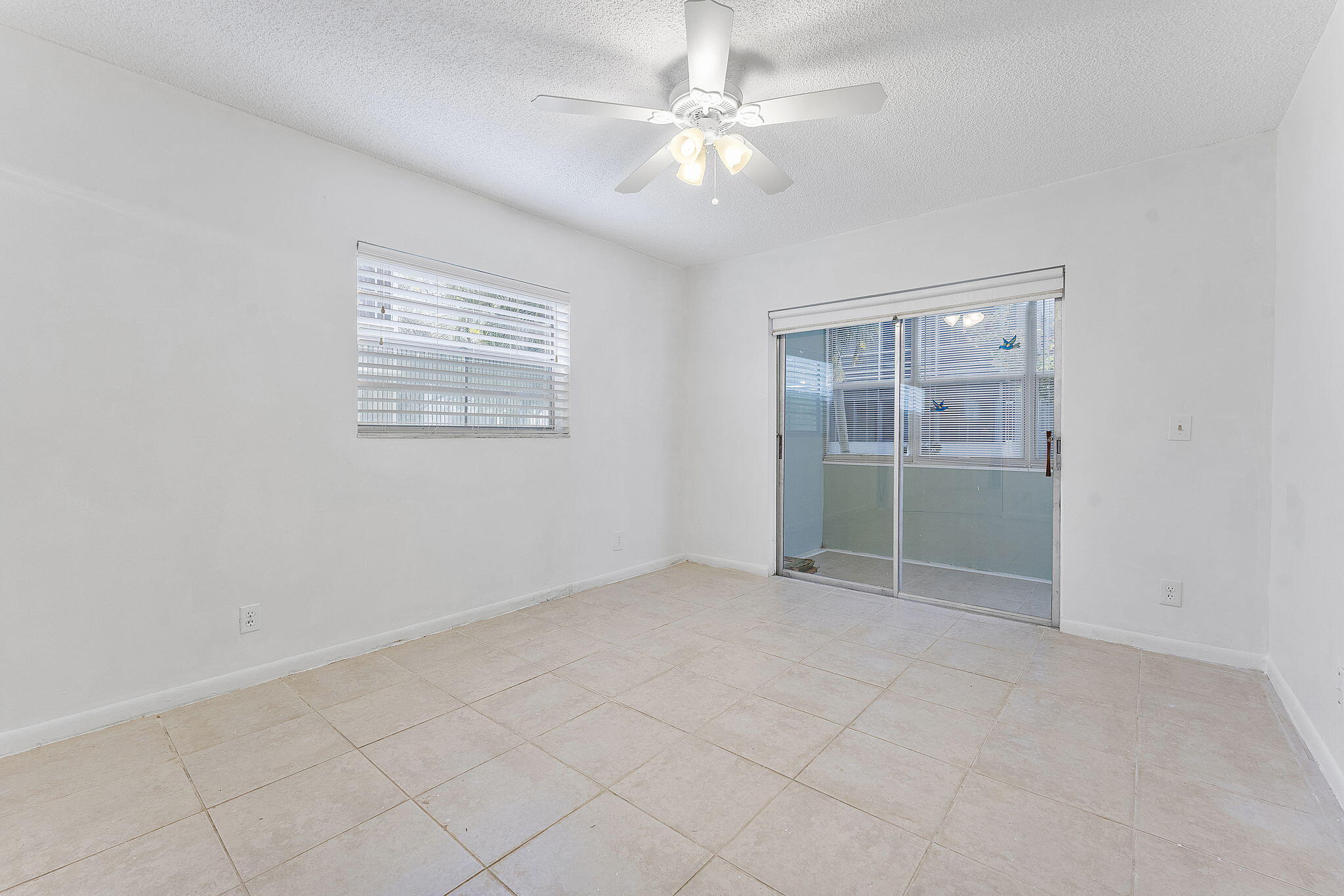 877 Flanders South Delray Beach, FL 33484 - Photo 19 of 27 an empty room with chandelier fan