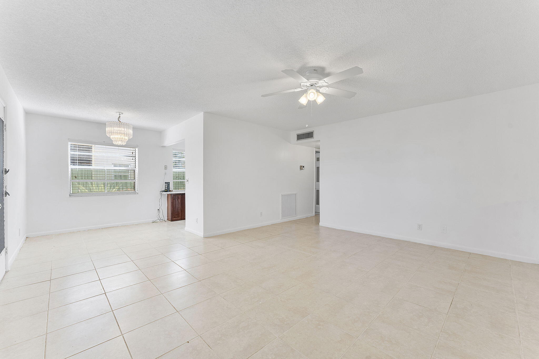877 Flanders South Delray Beach, FL 33484 - Photo 8 of 27 an empty room with fan and windows