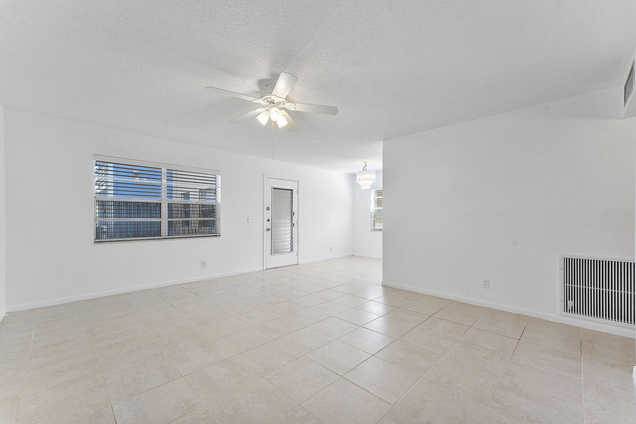 877 Flanders South Delray Beach, FL 33484 - Photo 9 of 27 en empty room with windows and ceiling fan