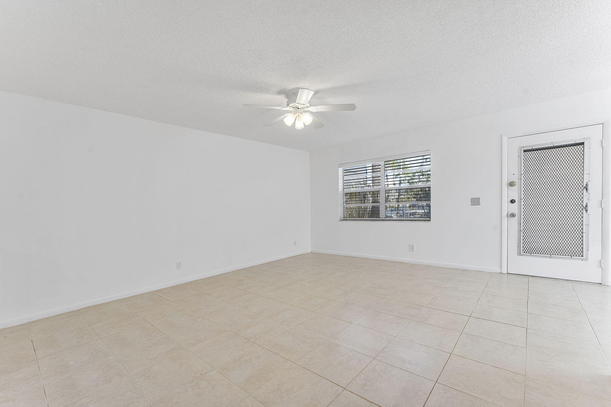 877 Flanders South Delray Beach, FL 33484 - Photo 10 of 27 wooden floor in an empty room with a window