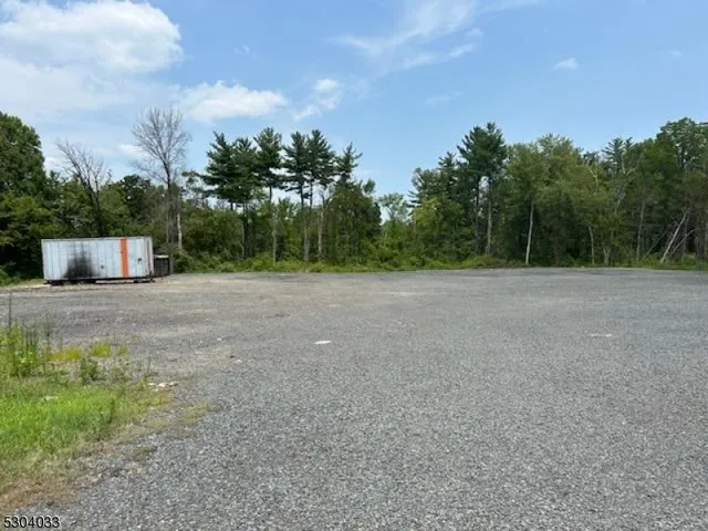 a view of a field with a tree in the background