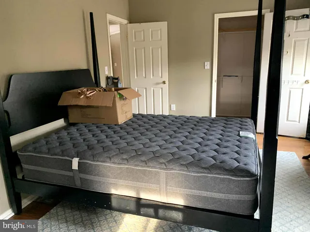 a room with a large bed and a dresser