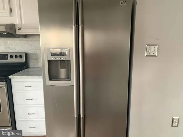 a kitchen with a refrigerator and a stove