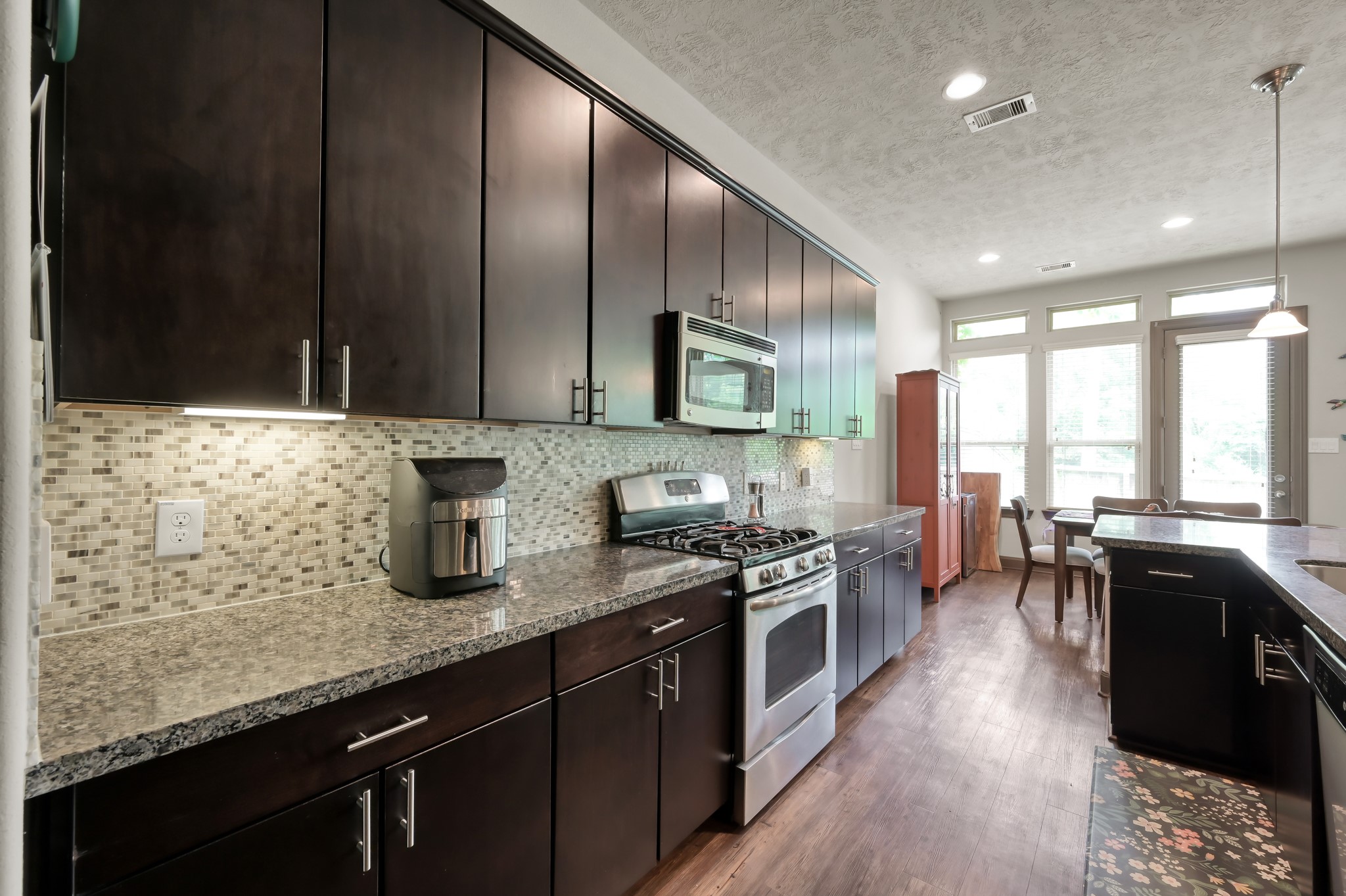 18 Aventura Place Spring, TX 77389 - Photo 20 of 43 a kitchen with stainless steel appliances granite countertop sink stove top oven and cabinets