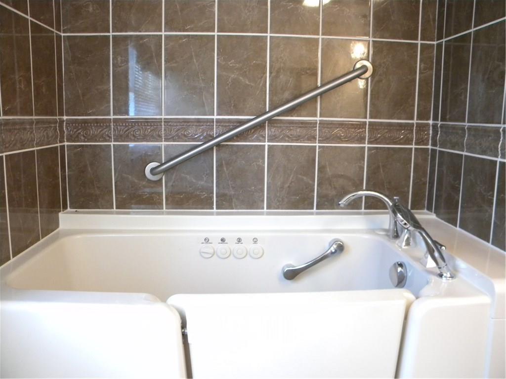 208 Springdale Road Venetia, PA 15367 - Photo 15 of 25 MBR bath with walk-in jetted tub and hand-held shower; ceramic tile surround.