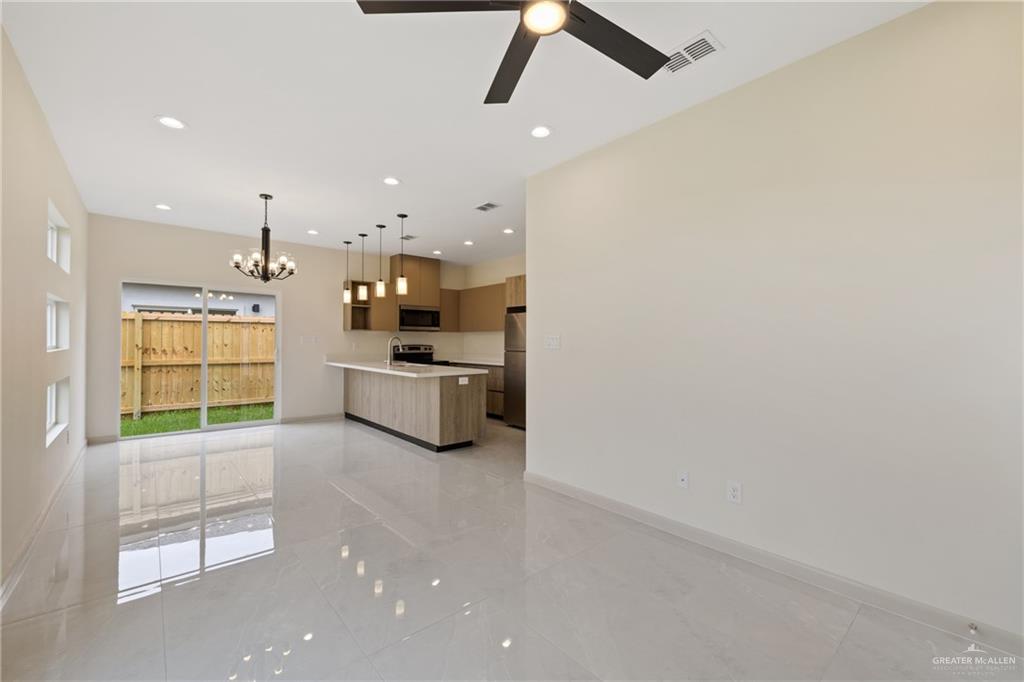 1906 West Violet Drive, Unit 4 Pharr, TX 78577 - Photo 3 of 10 a large kitchen with a sink stainless steel appliances and cabinets