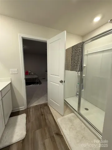 a bathroom with a glass shower door and a sink