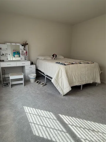 a front view of a house with a yard and potted plants