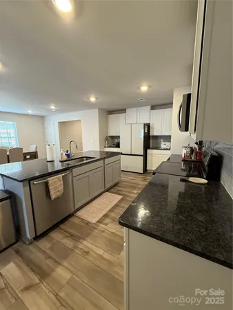 a kitchen with stainless steel appliances granite countertop a sink counter space and cabinets