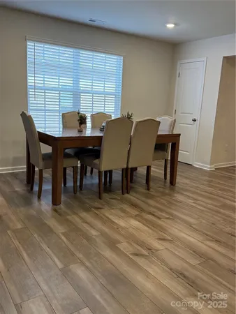 a view of a dining room with furniture and window