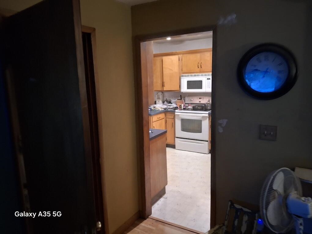 304 Maple Avenue Forreston, IL 61030 - Photo 6 of 7 a kitchen with a refrigerator and a stove