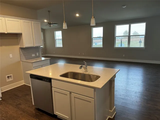 a kitchen with a sink and chandelier