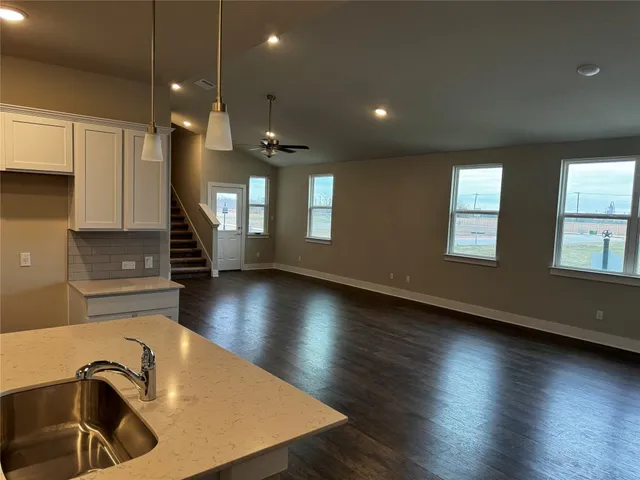 a view of a room with wooden floor and a sink