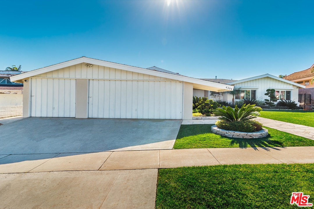 4304 Olympiad Drive View Park, CA 90043 - Photo 2 of 44 a backyard of a house with yard and outdoor seating