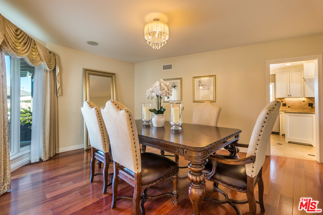 4304 Olympiad Drive View Park, CA 90043 - Photo 15 of 44 a dining room with furniture and wooden floor