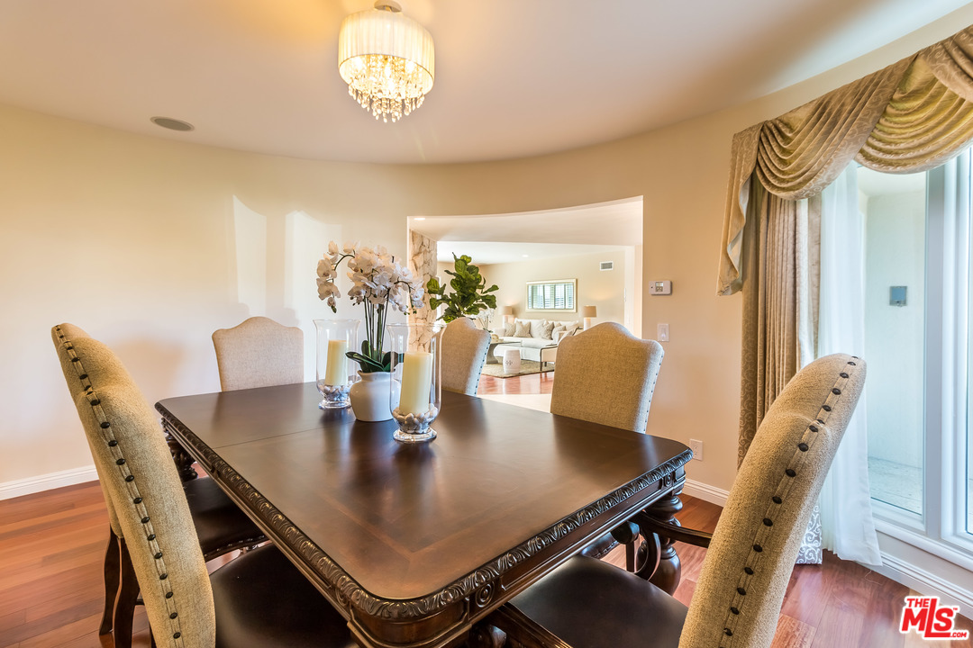 4304 Olympiad Drive View Park, CA 90043 - Photo 16 of 44 a view of a dining room with furniture and wooden floor