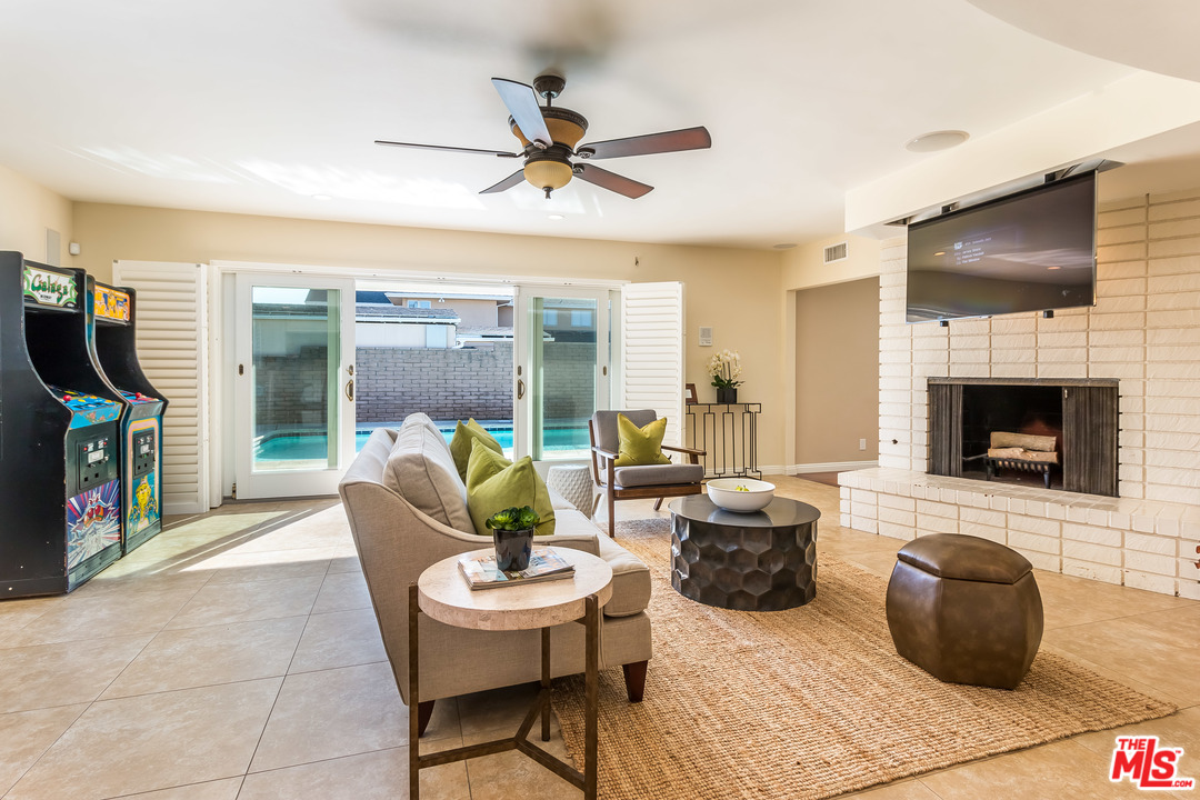 4304 Olympiad Drive View Park, CA 90043 - Photo 17 of 44 a living room with furniture a flat screen tv and a fireplace
