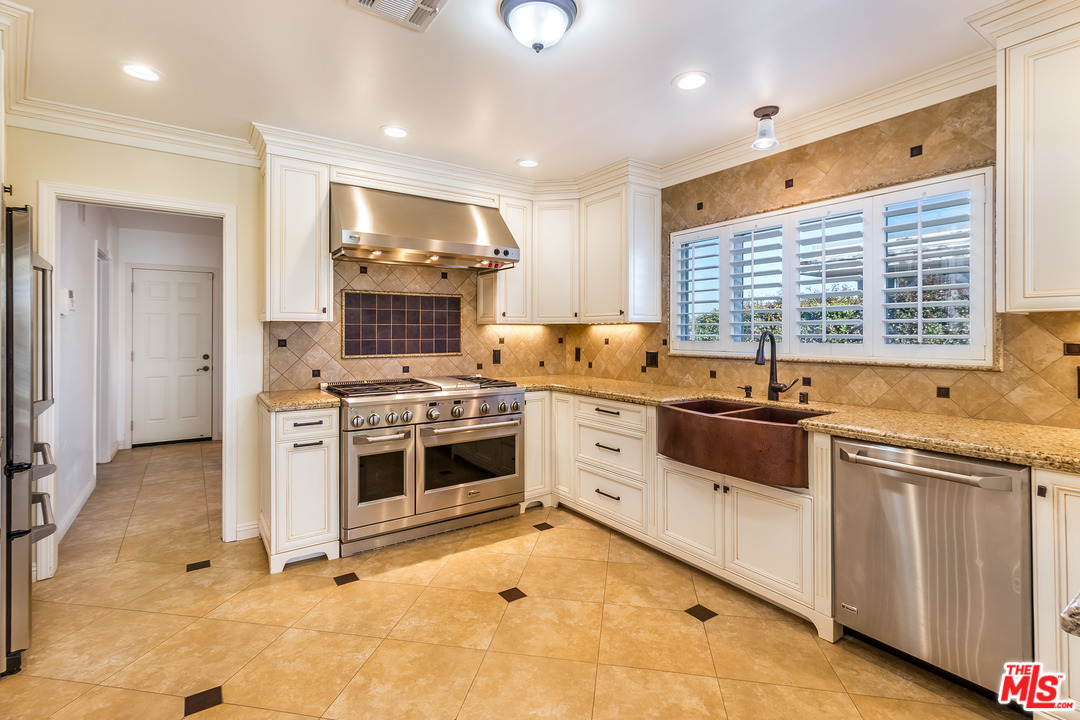 4304 Olympiad Drive View Park, CA 90043 - Photo 21 of 44 a kitchen with stainless steel appliances a stove a sink and a refrigerator