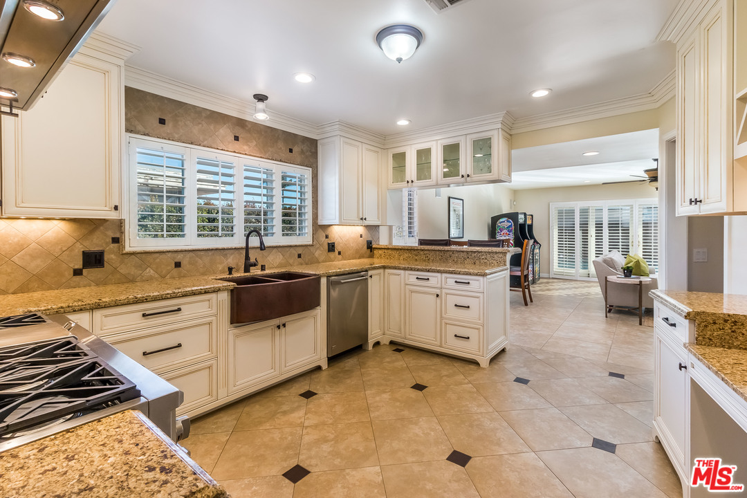 4304 Olympiad Drive View Park, CA 90043 - Photo 26 of 44 a kitchen that has a sink a stove and cabinets