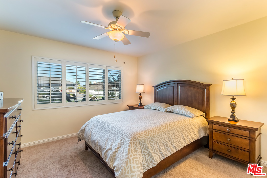 4304 Olympiad Drive View Park, CA 90043 - Photo 27 of 44 a bedroom with a large bed and a chandelier