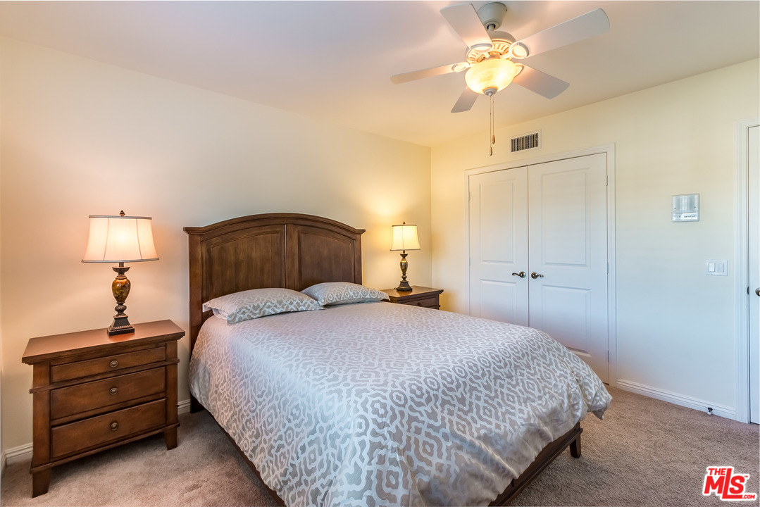 4304 Olympiad Drive View Park, CA 90043 - Photo 28 of 44 a bedroom with a bed and a chandelier