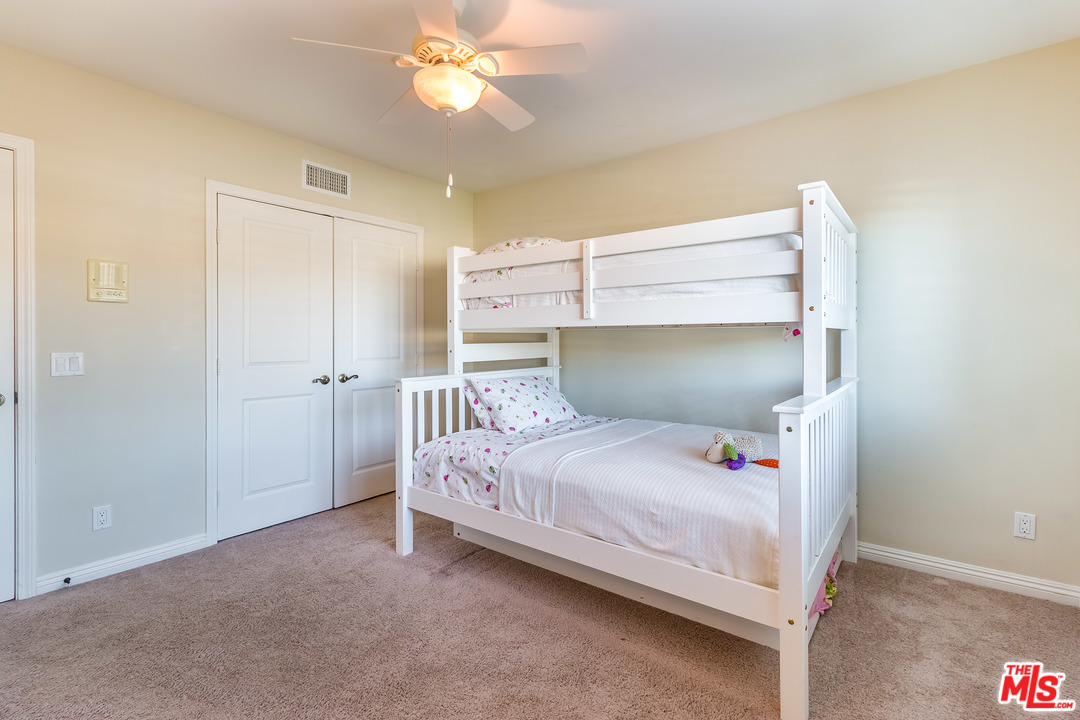 4304 Olympiad Drive View Park, CA 90043 - Photo 30 of 44 a bedroom with a bed and a chandelier