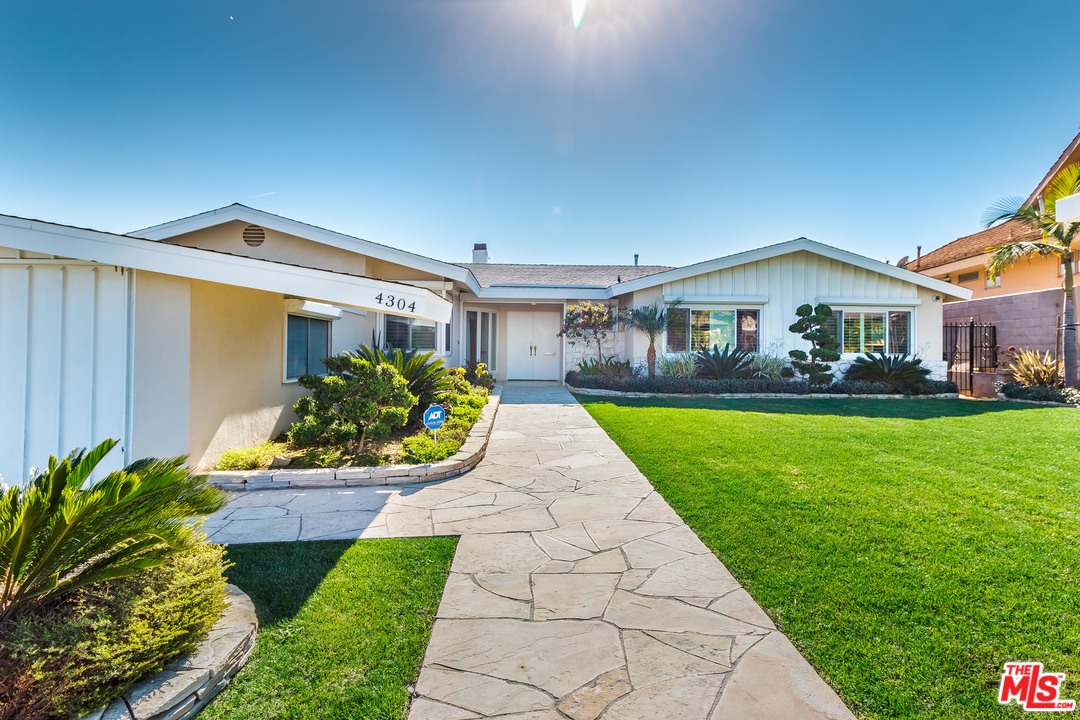 4304 Olympiad Drive View Park, CA 90043 - Photo 4 of 44 a front view of a house with garden