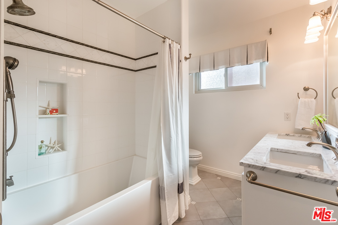 4304 Olympiad Drive View Park, CA 90043 - Photo 31 of 44 a bathroom with a sink a toilet and shower