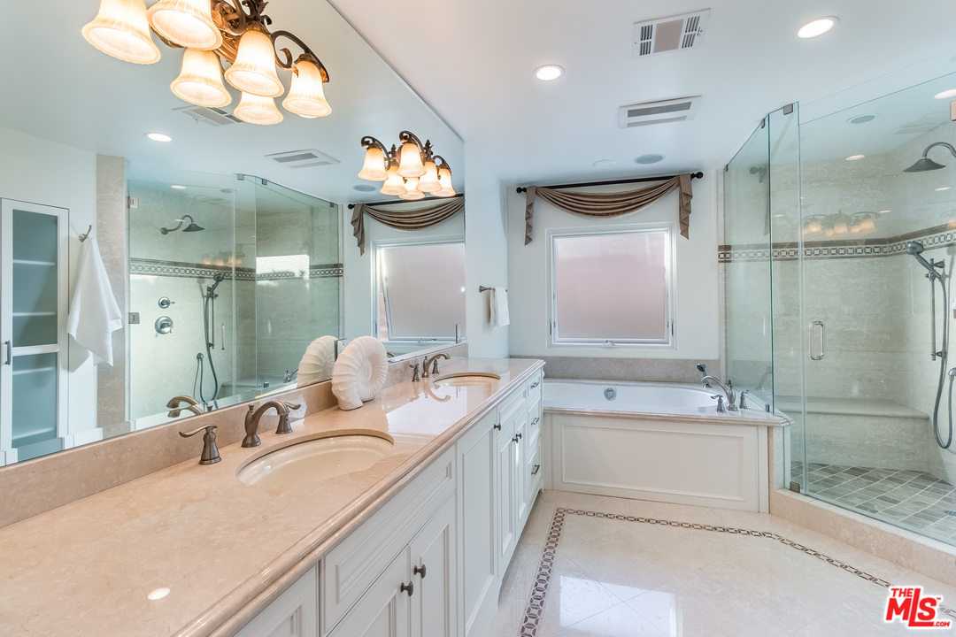 4304 Olympiad Drive View Park, CA 90043 - Photo 32 of 44 a bathroom with a sink a large mirror and a shower